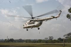 A United Nations helicopter lands in a field in Itipo, a remote village affected by the Ebola outbreak. The field had to be cleared by hand so that the helicopter could land and the response team could set up a base camp in the area.
