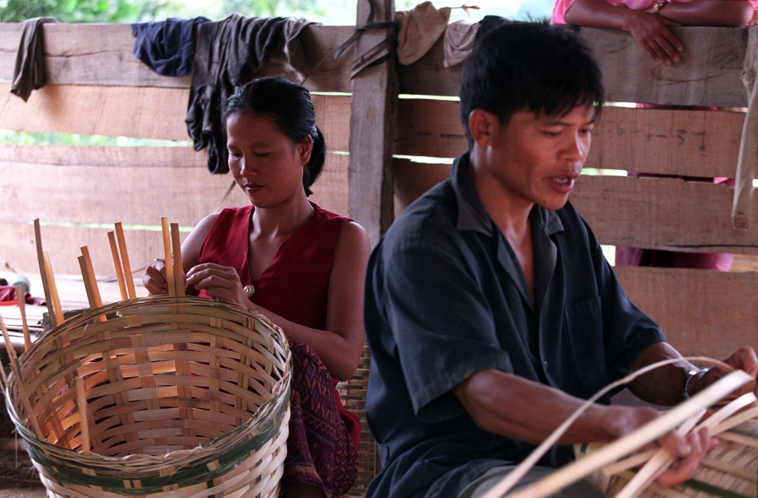 A young couple working side by side, Lao