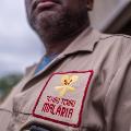 An employee wearing the uniform of Tchau Tchau Malaria (“Bye-bye Malaria”), a non-profit organization founded by a group of African entrepreneurs and an implementing partner for the government’s IRS programme.