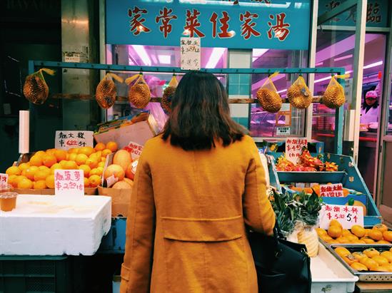 lady in front of a fruit shop